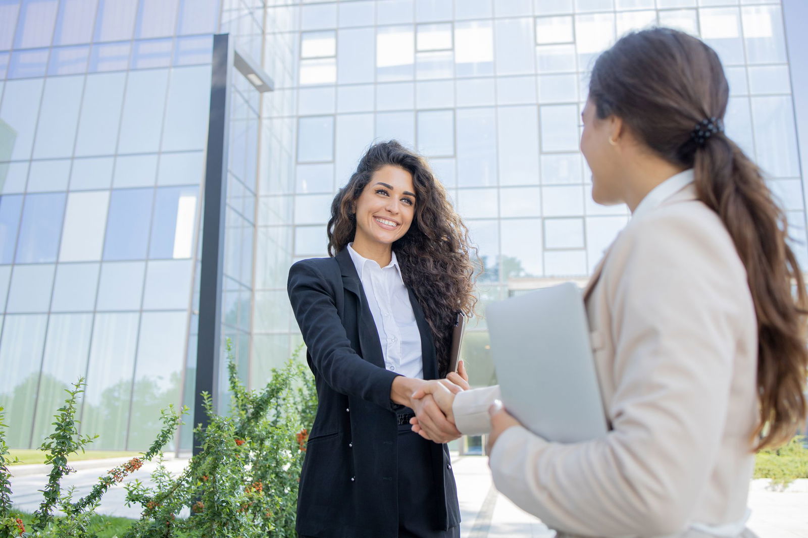 Two-businesswomen-are-talking-outside-1643050581_2125x1416.jpeg