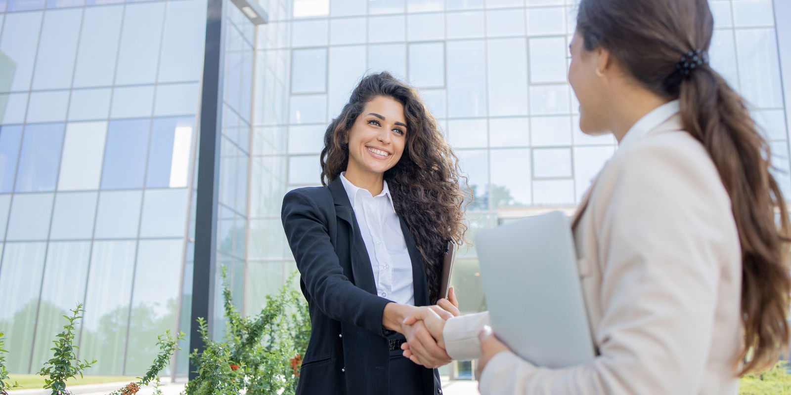 Two-businesswomen-are-talking-outside-1643050581_2125x1416.jpeg